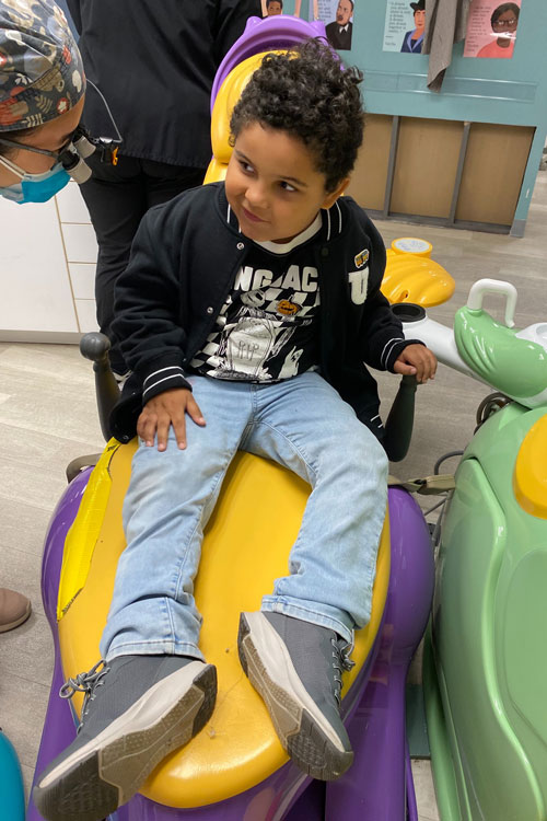 Miles in the dental chair with a hygienist talking with him