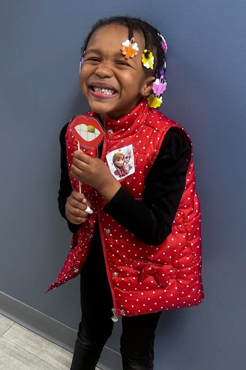 young girl with hair braids smiling